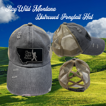 A distressed gray ponytail hat with "Stay Wild Montana" embroidery.