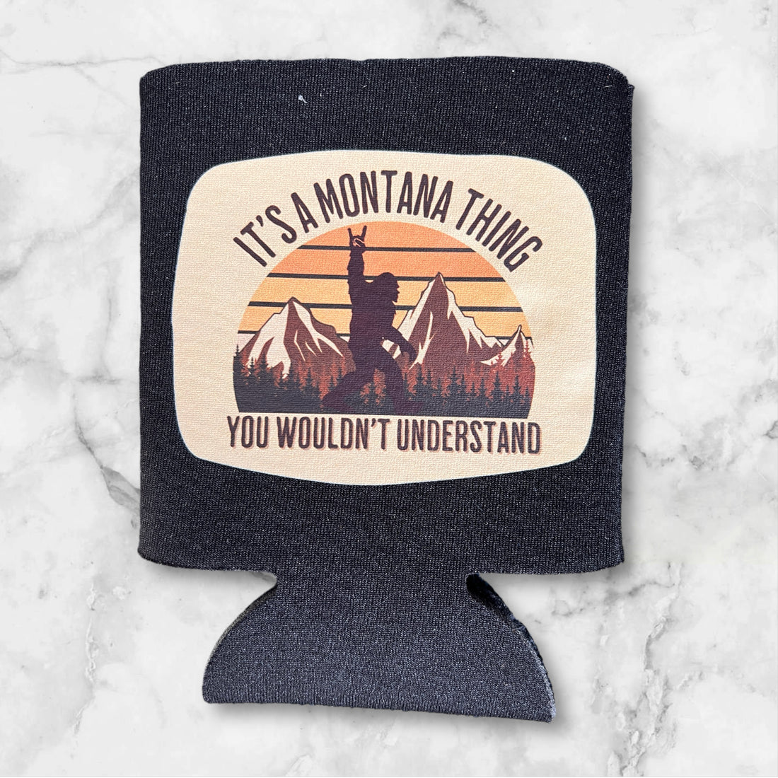  Image of the "It's a Montana Thing You Wouldn't Understand" Drink Koozie, featuring a fun slogan print, perfect for adding Montana charm to your drinkware collection while keeping beverages cool.