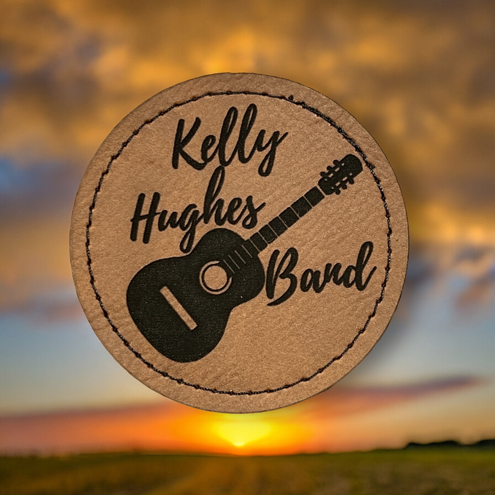  Image of the Kelly Hughes Band Round Patch, featuring the band's logo in vibrant colors, ideal for adding a pop of personality to clothing or accessories.