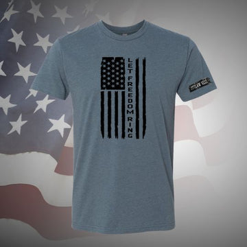 Image of the Let Freedom Ring T-Shirt in Indigo featuring the patriotic slogan, perfect for expressing your love for freedom with comfort and style on any occasion.
