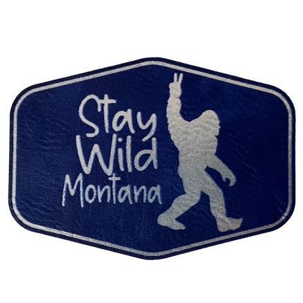 A blue and silver hexagon patch with "Stay Wild Montana" lettering.