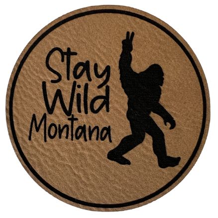A light brown round patch with "Stay Wild Montana" inscription.