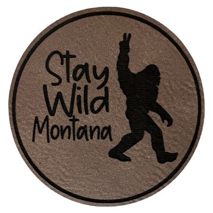 A grey round patch with "Stay Wild Montana" inscription.