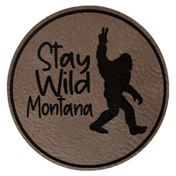 A grey round patch with "Stay Wild Montana" inscription.