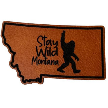 A rawhide Montana-shaped patch with "Stay Wild Montana" inscription.