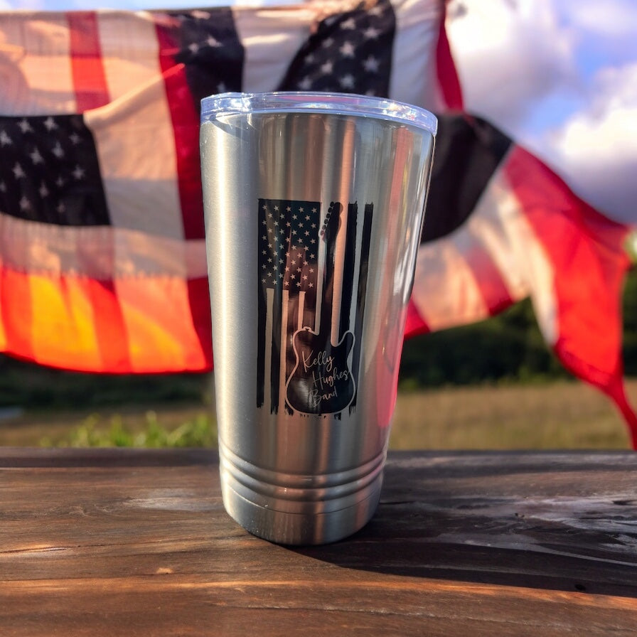 Image of the Kelly Hughes Band American Flag Guitar Tumbler, featuring a vibrant American flag guitar design, perfect for music enthusiasts and patriots, with stainless steel construction and spill-resistant lid for on-the-go enjoyment.