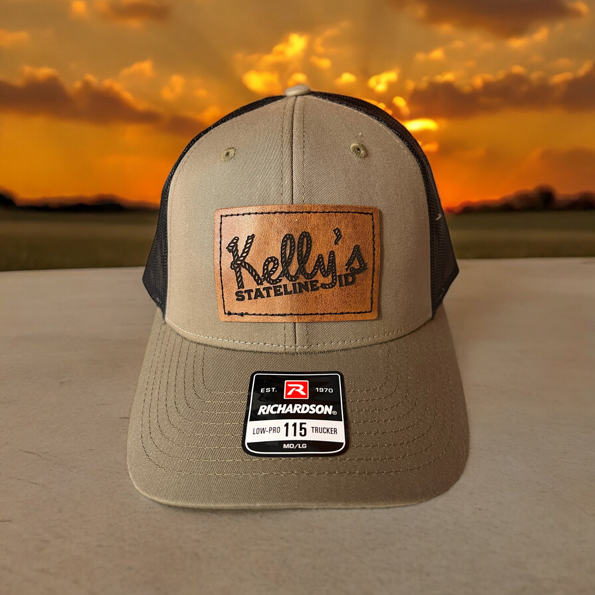  Image of the Kelly Hughes Stateline Richardson Cap with a brown patch, featuring an integrated ID slot, perfect for showcasing style and convenience at events with durable construction and a comfortable fit.
