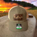 Image of the Kelly Hughes Stateline Richardson Cap with a rustic patch, featuring an integrated ID slot, perfect for showcasing style and convenience at events with durable construction and a comfortable fit.