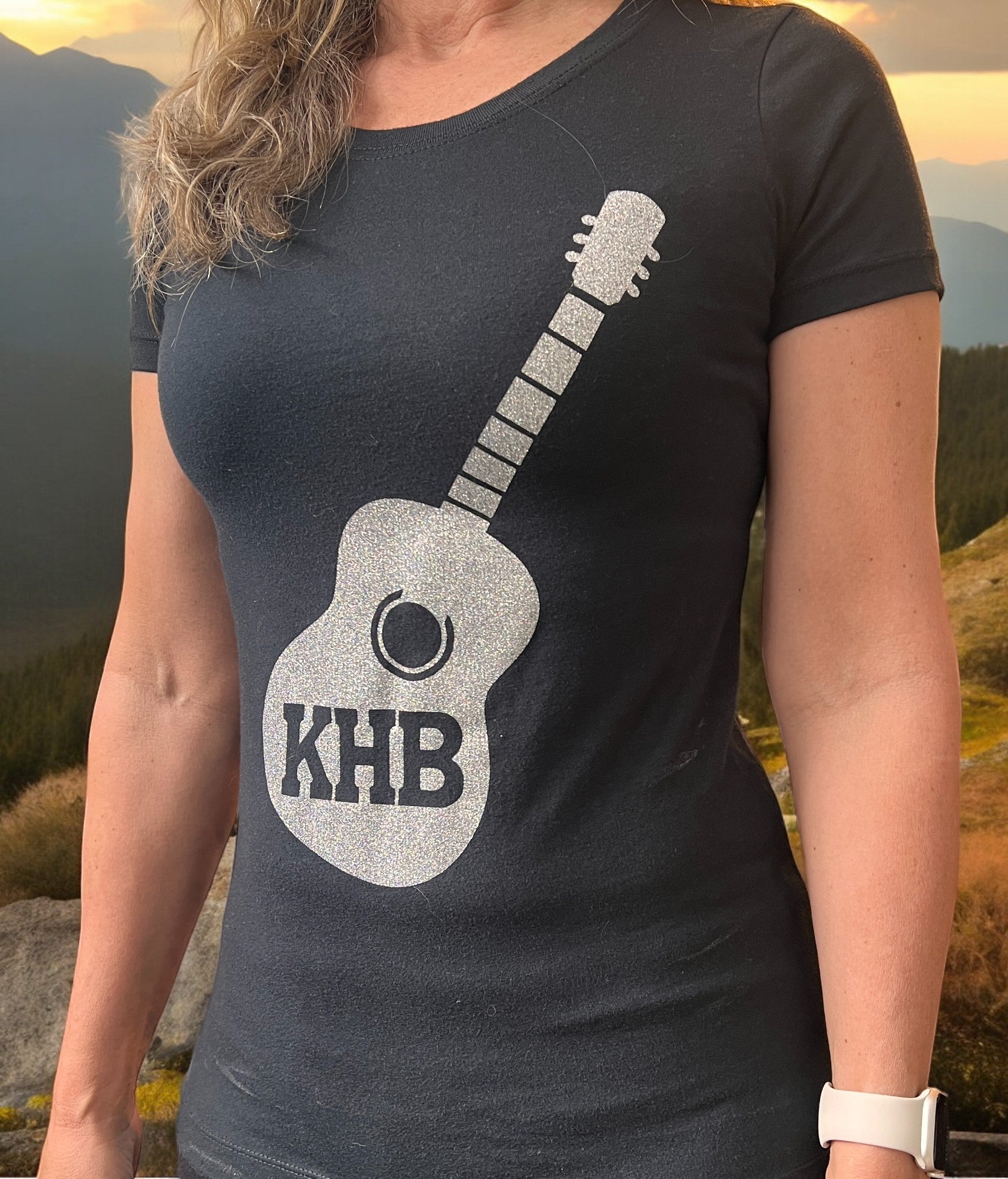 Image of the Kelly Hughes Band Sparkle Tee, featuring a glittery "Sparkle" slogan print, perfect for adding some glam to your outfit and standing out in style.