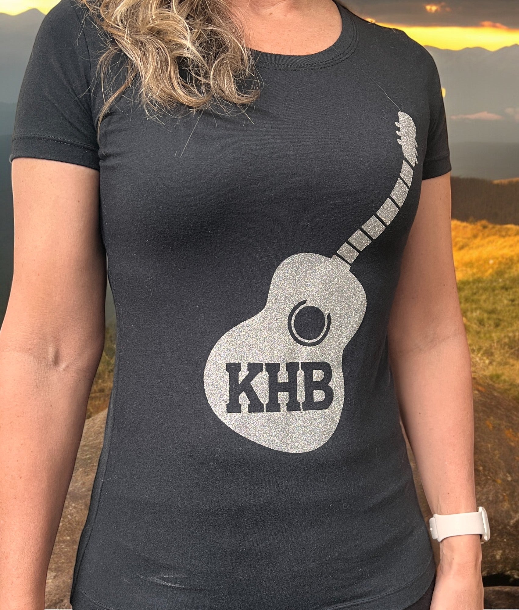 Image of the Kelly Hughes Band Sparkle Tee, featuring a glittery "Sparkle" slogan print, perfect for adding some glam to your outfit and standing out in style.