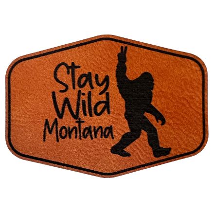 A rawhide hexagon-shaped patch with "Stay Wild Montana" inscription.