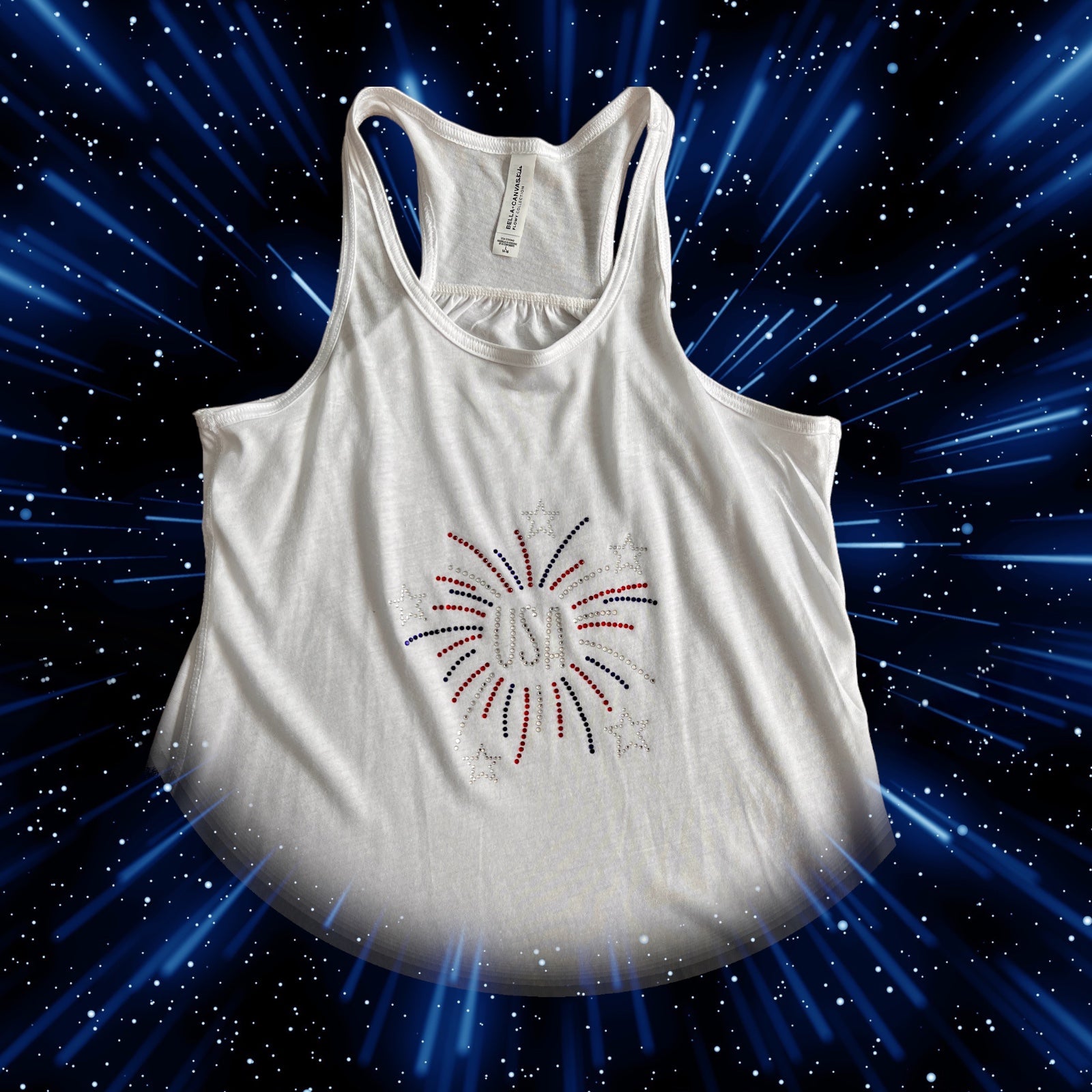 A girls' youth racerback tank with a "USA Fireworks" design, perfect for Independence Day celebrations, featuring fireworks emoji and American flag emoji.