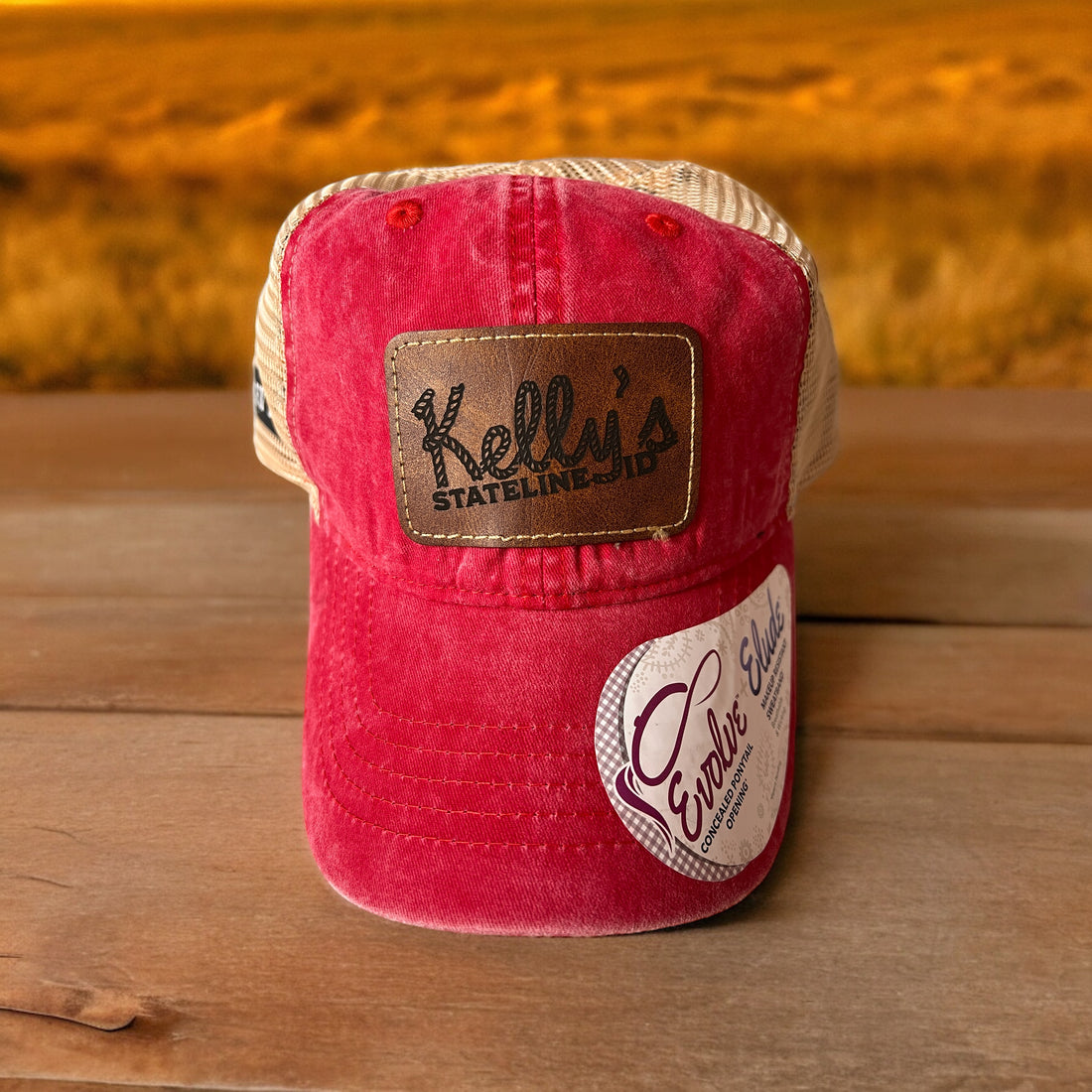  Image of Kelly's Stateline Red/Leopard Ponytail Cap with a brown patch, featuring an integrated ID slot, perfect for showcasing style and convenience at events with durable construction and a comfortable fit.