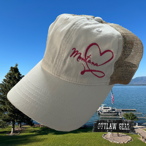 An embroidered white floral ponytail hat adorned with "Montana Love," a stylish accessory for expressing state pride with sophistication.